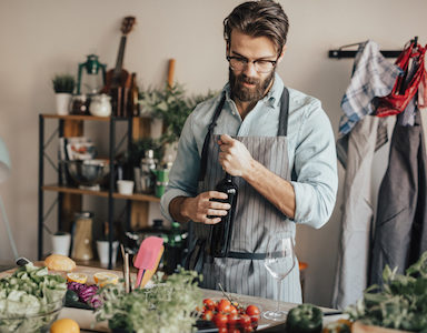 guy-with-wine-bottle-how-jusrt a splash to-cook-healthy-with-alcohol-featured-by-healthista