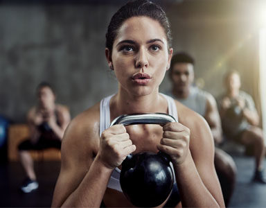 woman-with-Kettlebell,-anti-ageing-workouts-by-healthista.com