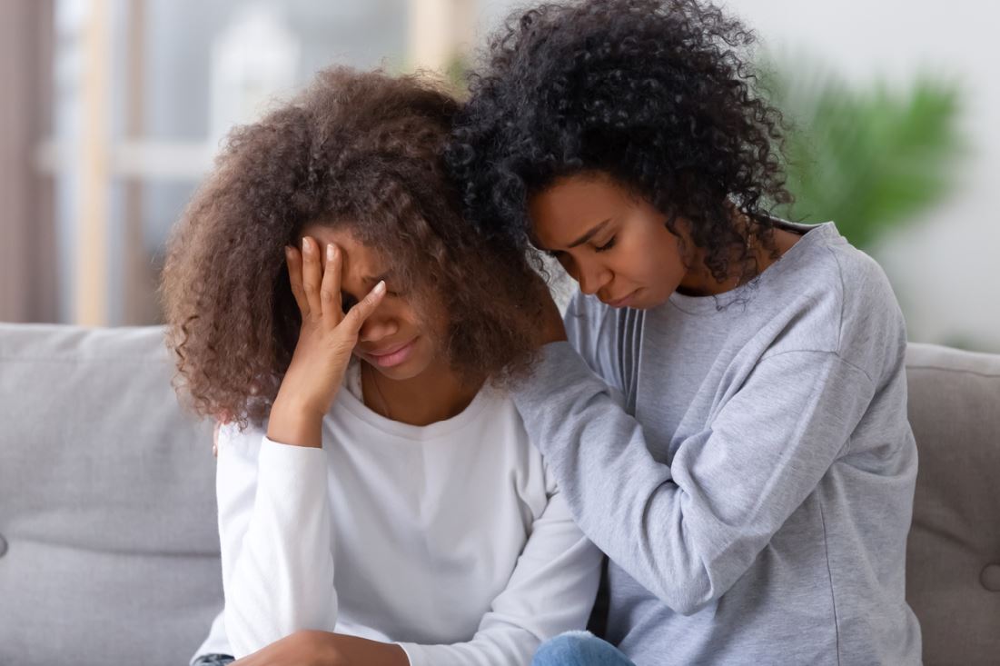 Woman comforting depressed friend suicide prevention