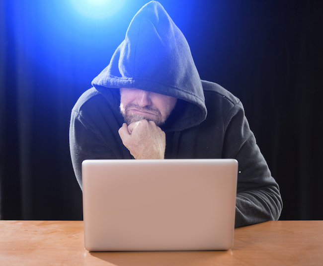 man-in-hood-on-laptop-cyber-stalking-healthista.com_.jpg