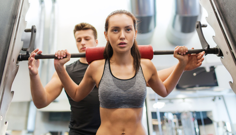 man-standing-behind-woman-on-squat-rack-healthista.com_.jpg