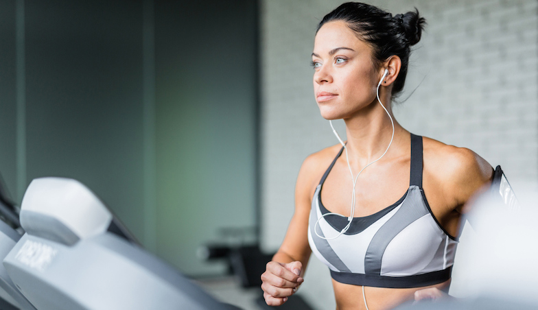 woman on treadmill with earphones in, healthista.com 