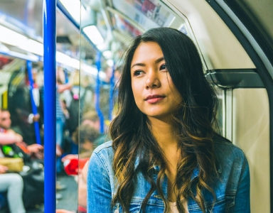 woman on train avoiding catching a cold