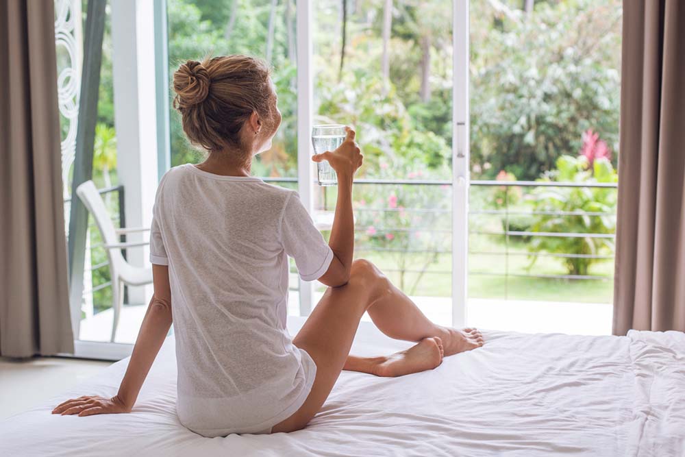 Woman-drinking-water-at-home-retreat.jpg