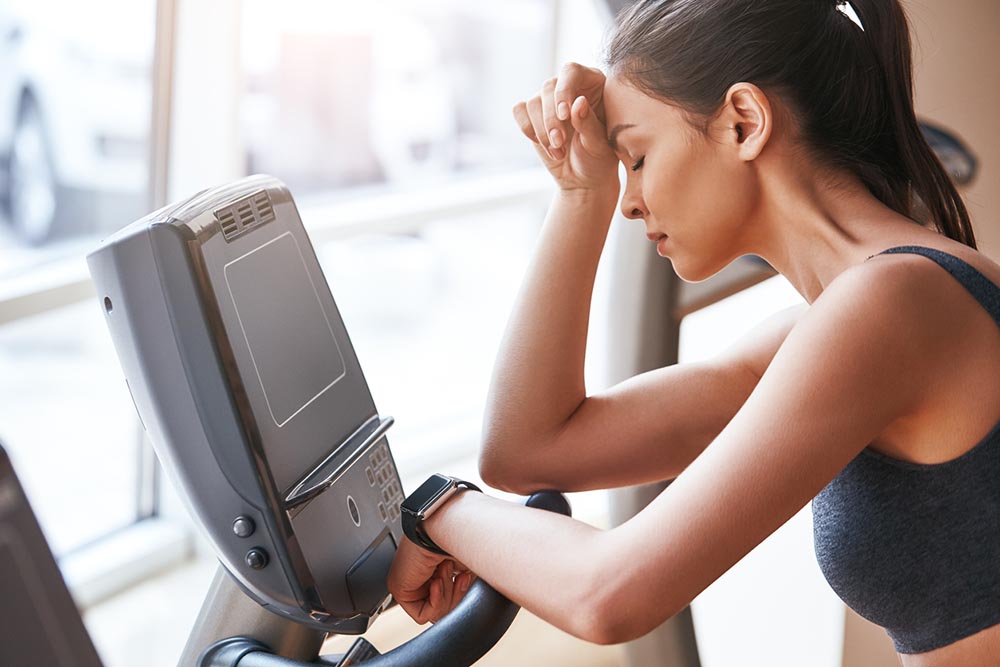 transformation-wk-10-woman-looking-tired-and-stressed-in-gym.jpg