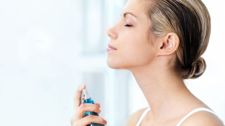 best face mists 7 brilliant ways to use a face mist - woman spraying face - in post 1