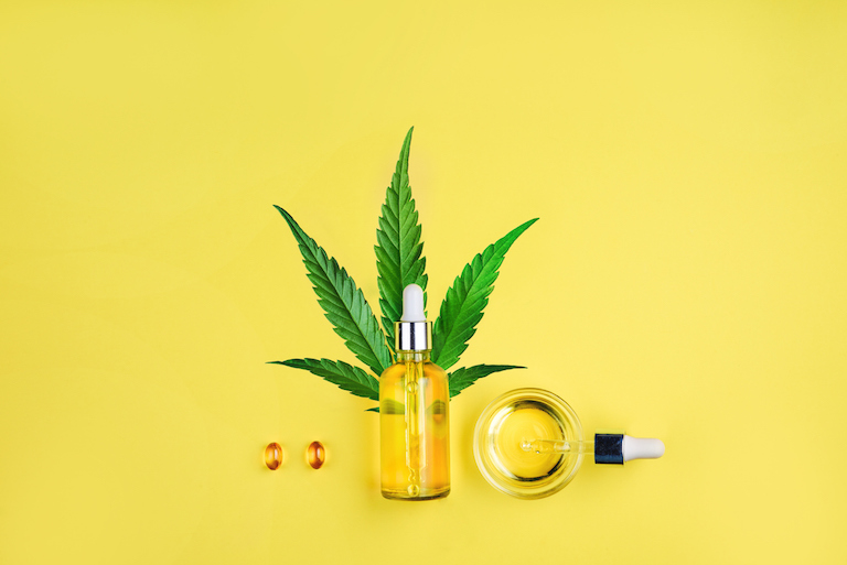 Bottle with CBD oil, pipette, capsules