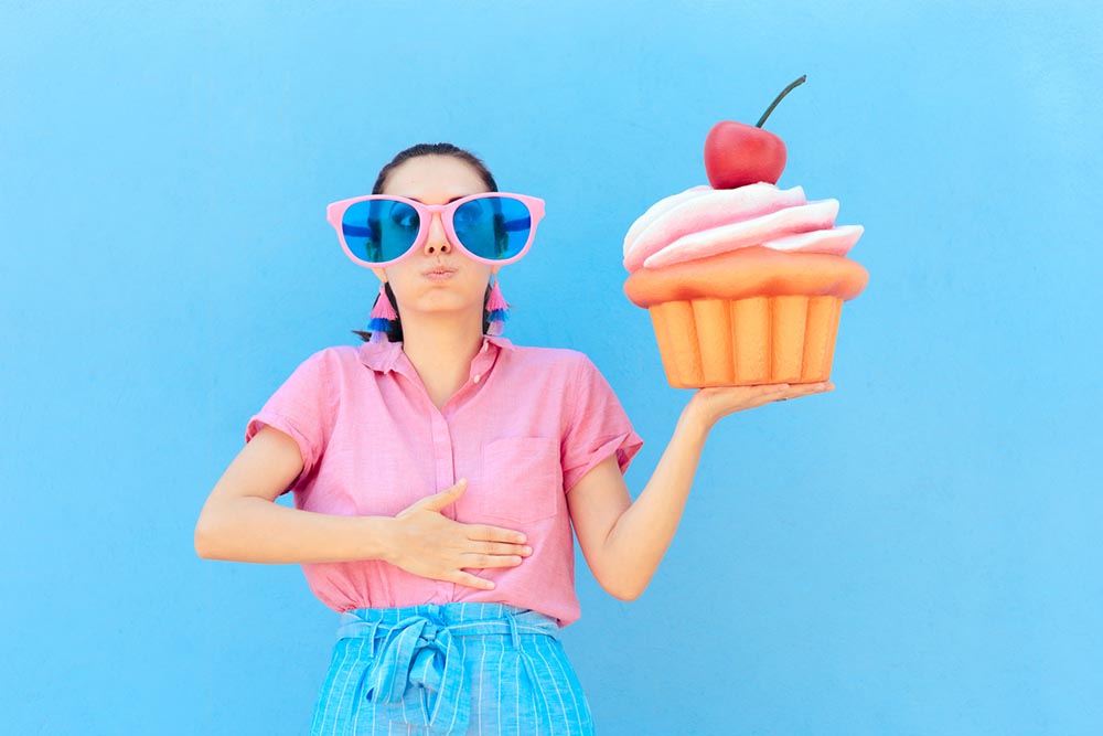 bad-habits-eating-too-much-sugar-woman-holding-cupcake.jpg