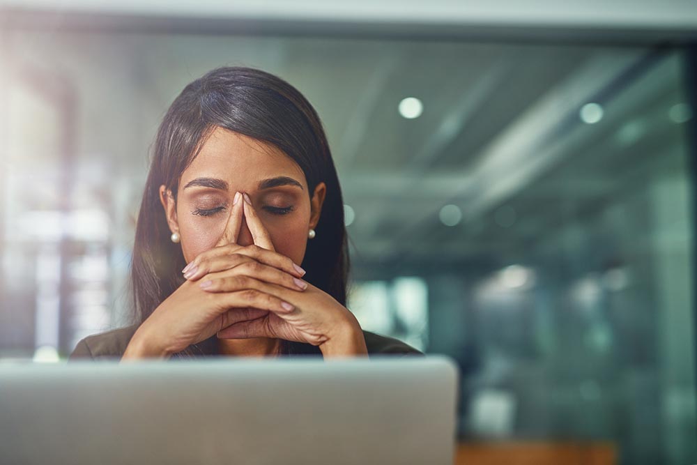 bad-habits-woman-under-pressure-at-work-sat-in-front-of-her-computer.jpg