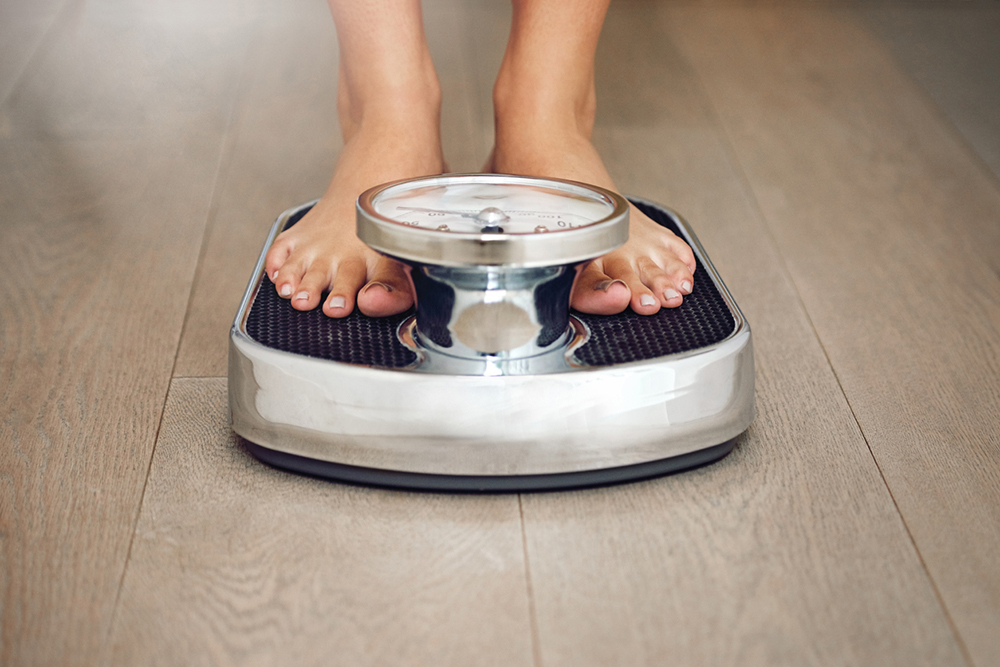 losing-weight-woman-stood-on-scales.jpg