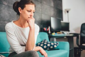 7 things every woman needs to know about the menopause stress can make menopause symptoms worse sad looking woman on sofa