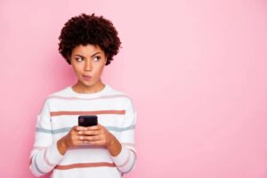 Decision making 6 ways to be less indecisive woman distracted and unsure on mobile