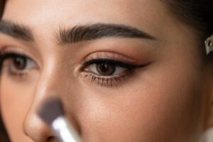 woman applying make up contact lenses rules