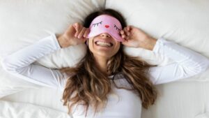 woman in bed smiling healthy habits