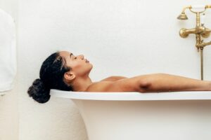 woman relaxing in the bath health rituals sore joints