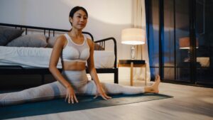 woman stretching in bedroom