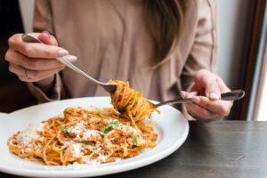 woman eating pasta