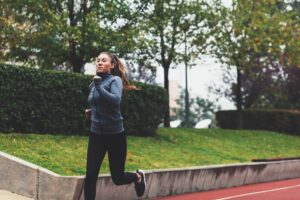 christmas fitness and health tips woman running through park fasted cardio