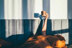 morning routine woman in bed with coffee