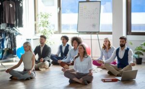 PHYSICAL WELLBEING AT WORK team meditating