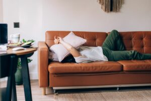 Feeling 'meh' Expert explains what Anhedonia is plus what can help woman looking bored on sofa