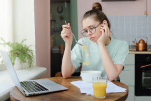 Feeling 'meh' Expert explains what Anhedonia is plus what can help woman looking bored while eating